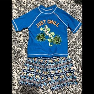 Matching swim trunks and rash guard. Swim trunks are 3T and rash guard is 4T.